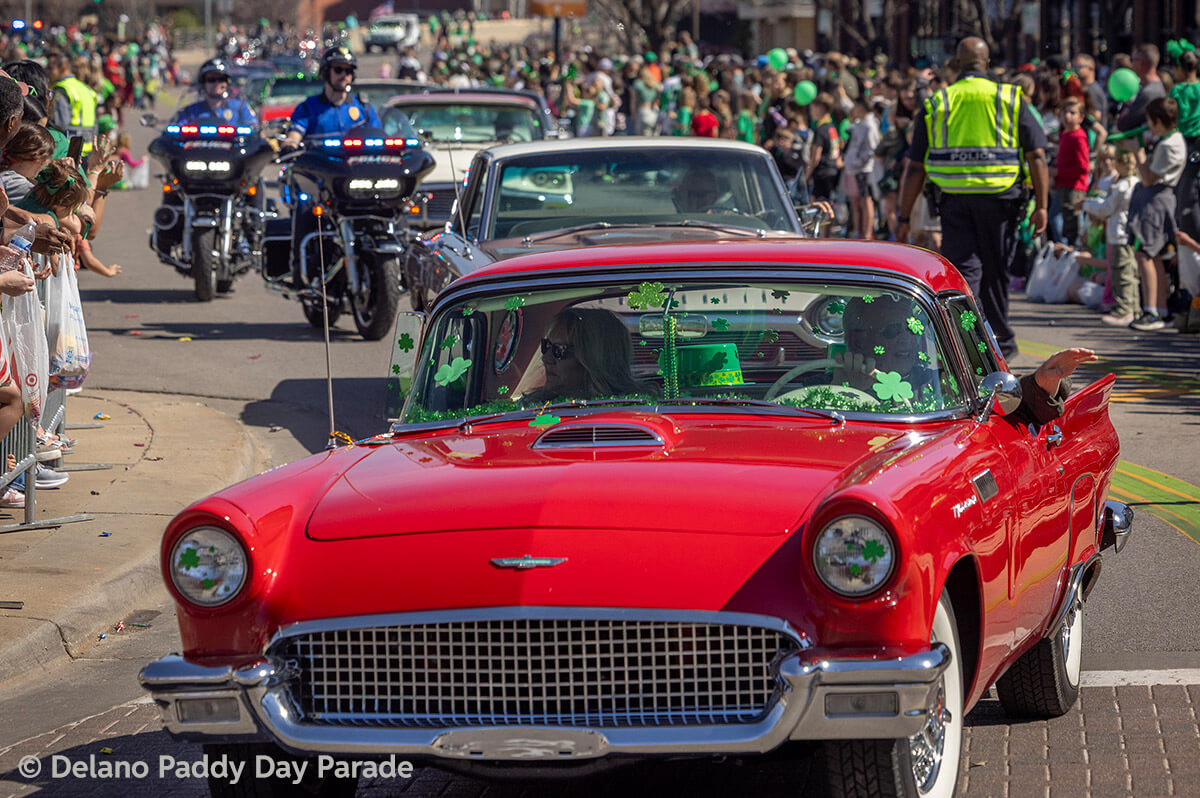 A cherry red classic car in the parade.