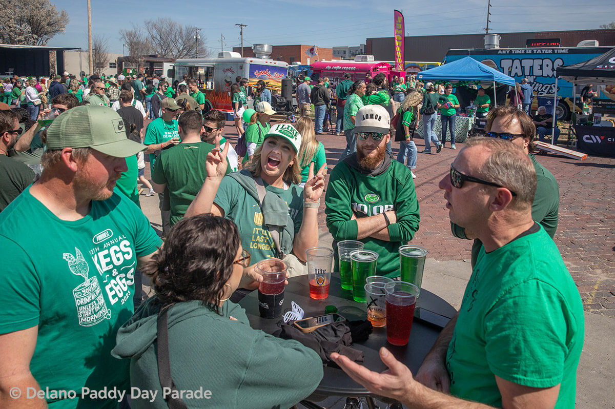 A woman playfully smiles to the camera while showing two peace signs.