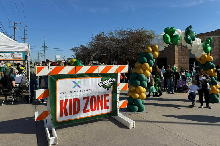 A banner for the Delano Paddy Day Parade Kid Zone event.