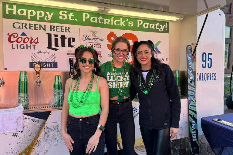 Three smiling parade volunteers.